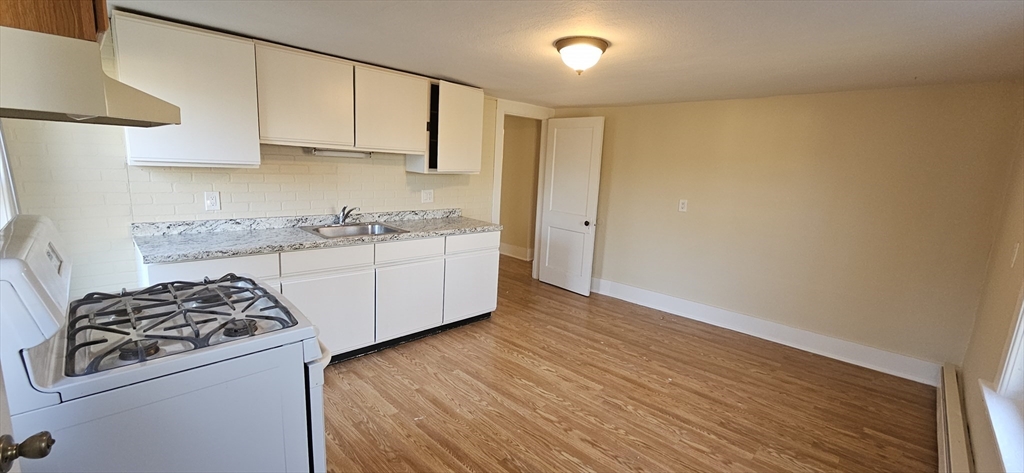 378 Boston Road Monson, MA 01069 - Photo 6 of 22 a kitchen with stainless steel appliances granite countertop a sink stove and cabinets
