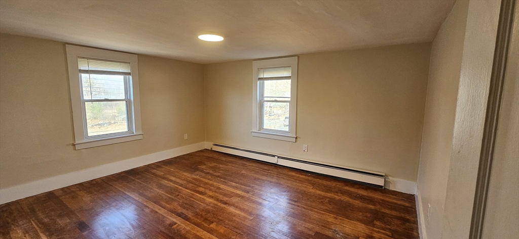 378 Boston Road Monson, MA 01069 - Photo 10 of 22 a view of an empty room with wooden floor and a window