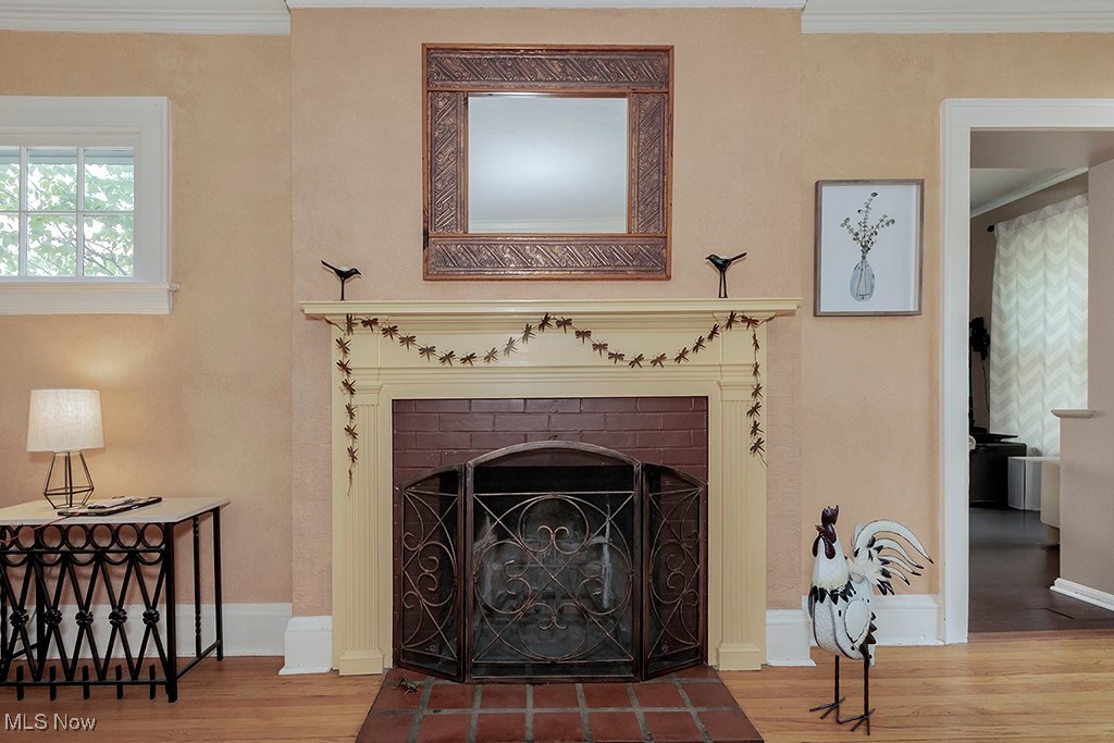 3256 Aberdeen Road Cleveland, OH 44120 - Photo 4 of 46 Interior details with hardwood / wood-style flooring, crown molding, and a brick fireplace