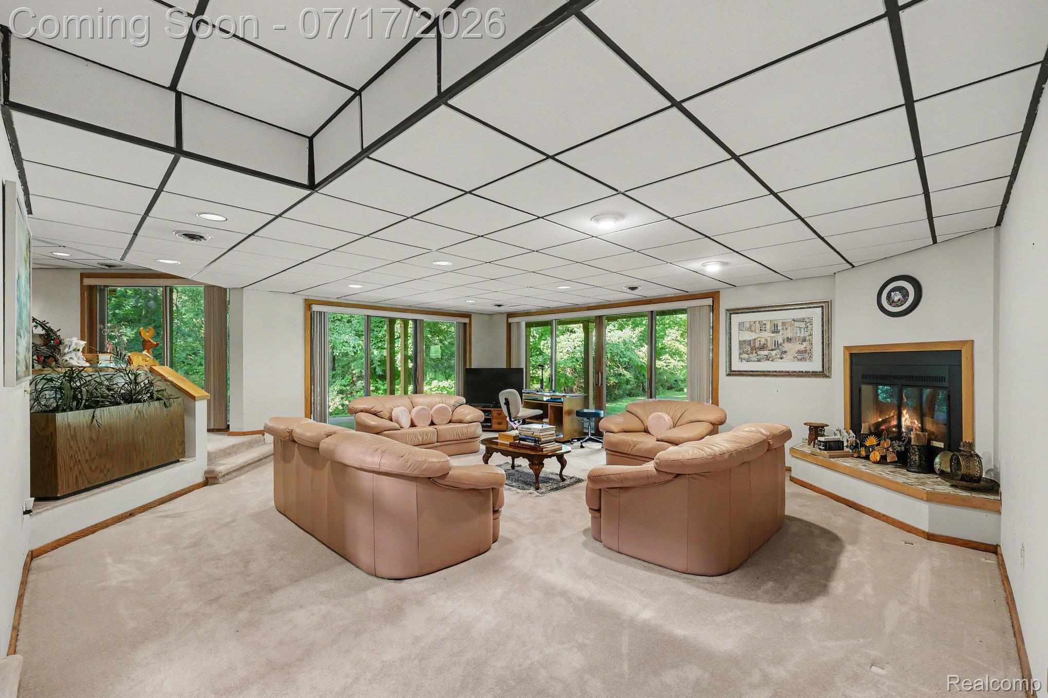 5685 Paint Valley Drive Rochester, MI 48306 - Photo 28 of 66 Spacious lower-level area with a fireplace featuring a stone hearth and wood mantel