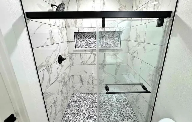 a bathroom with a shower and a window