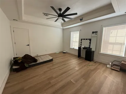 a living room with furniture window and a ceiling fan