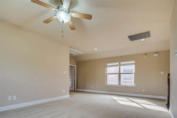 a view of an empty room with a fan