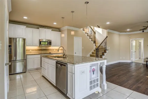 a kitchen with a sink appliances and cabinets