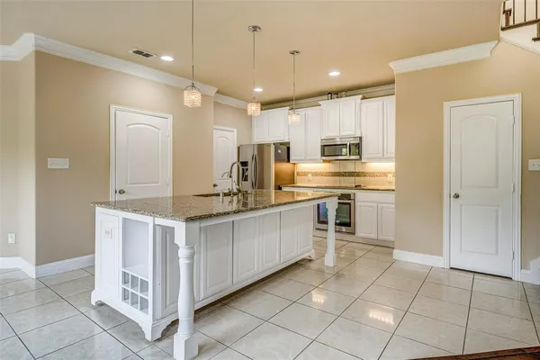a kitchen with a stove a sink and a refrigerator