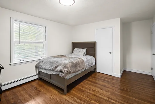 a bed sitting in a bedroom next to a window