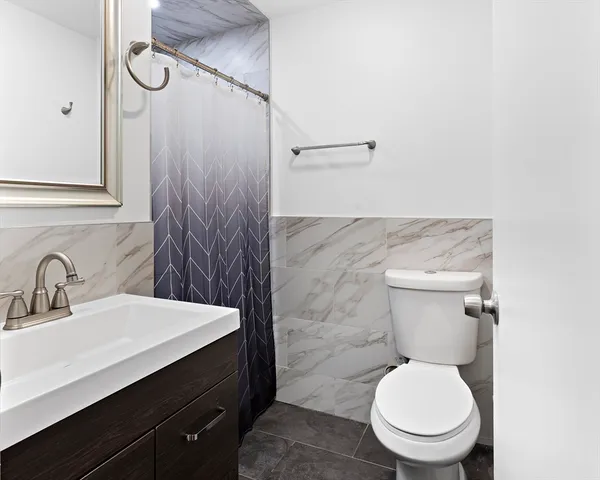 a bathroom with a toilet sink and shower