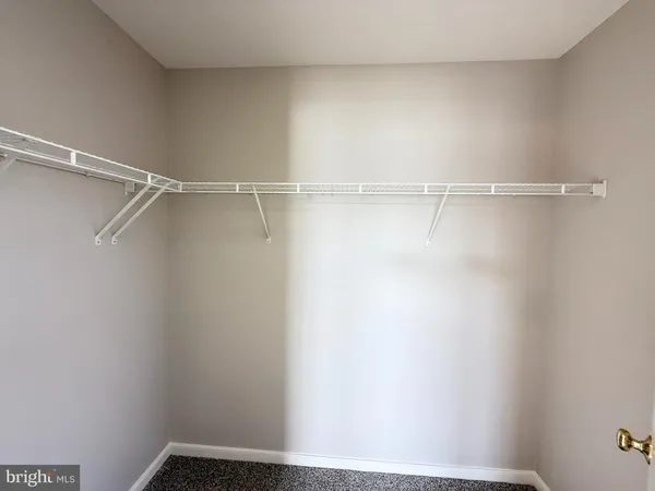 a spacious bathroom with a double vanity sink a toilet and a mirror