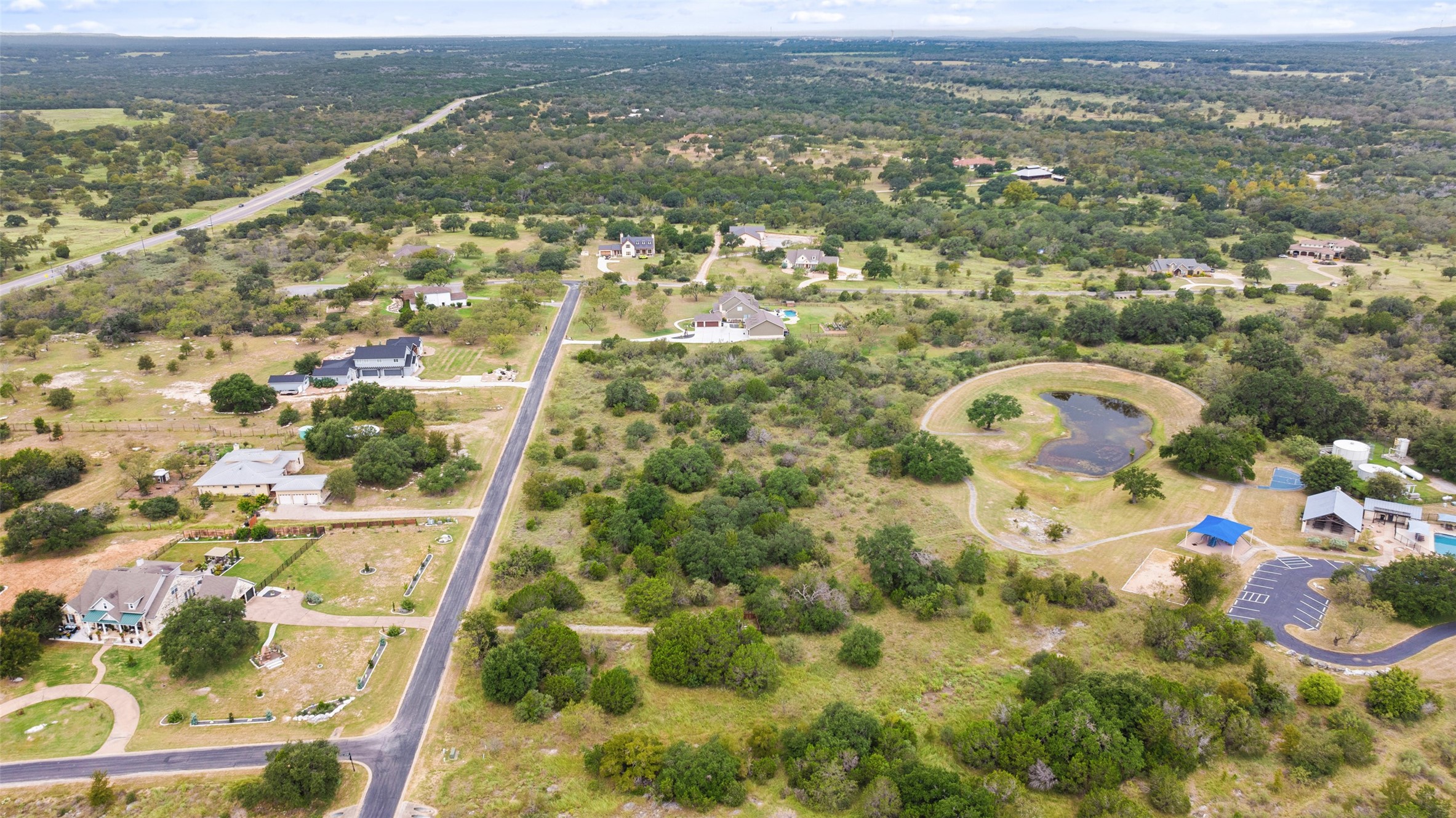 108 Cross Trail Spicewood, TX 78669 - Photo 4 of 33 The picturesque community pond is located behind the property, ensuring no neighboring homes in the rear.