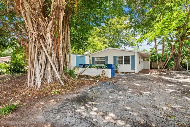 a view of a house with backyard and sitting area