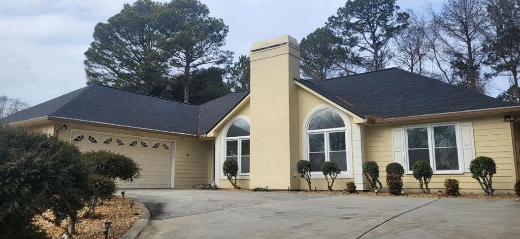 a view of a chairs and table in backyard of house