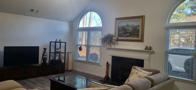 a living room with furniture fireplace and flat screen tv