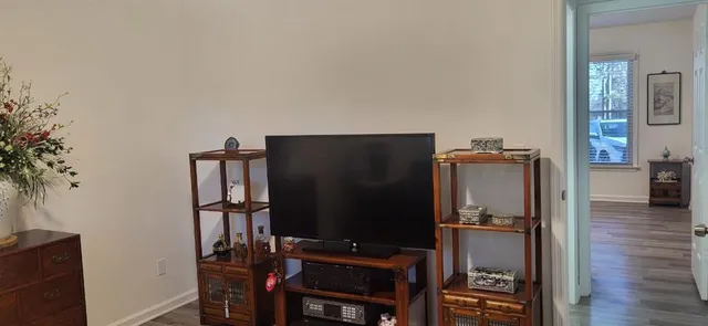 a view of workspace with wooden floor windows cabinet