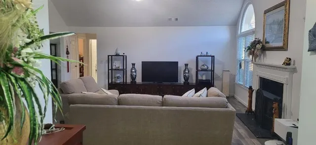 a living room with furniture and a fireplace