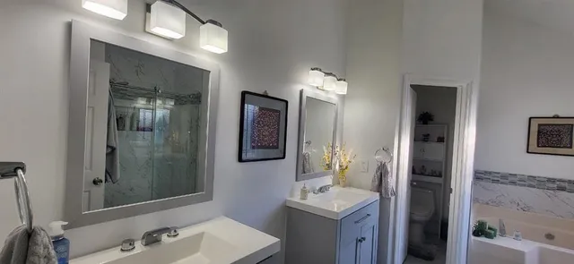a bathroom with a sink a light fixture and a mirror
