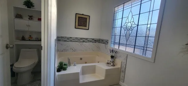 a bathroom with a bathtub and a shower