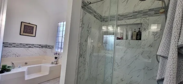 a bathroom with a bathtub and shower