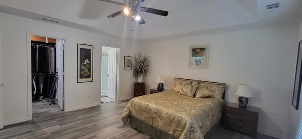 a bedroom with a bed and a chandelier