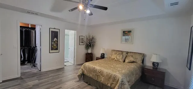 a bedroom with a bed and a chandelier