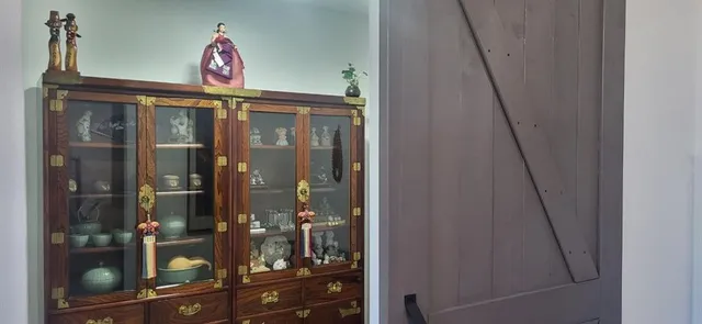 a bathroom with a toilet and a shower curtain