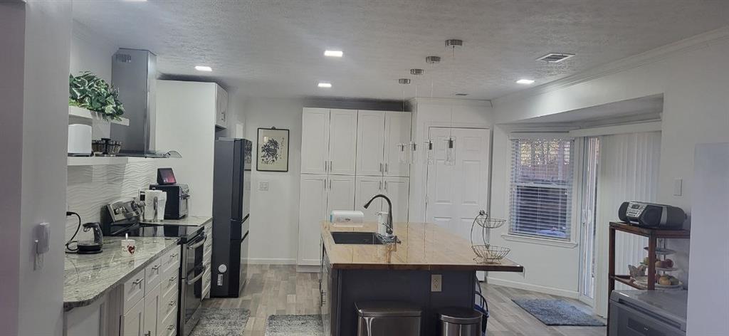 2341 Park Valley Way Dacula, GA 30019 - Photo 7 of 38 a view of a kitchen area with furniture and wooden floor