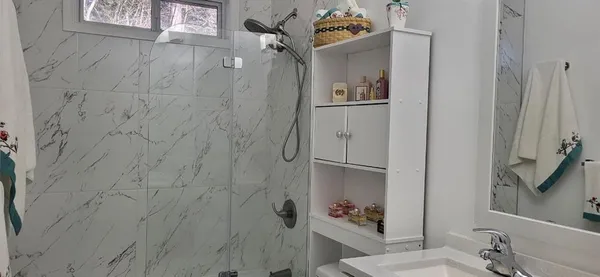 a bathroom with a sink and mirror with toilet