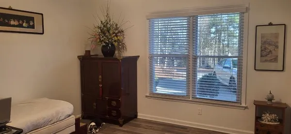 a room that has a window and a dresser