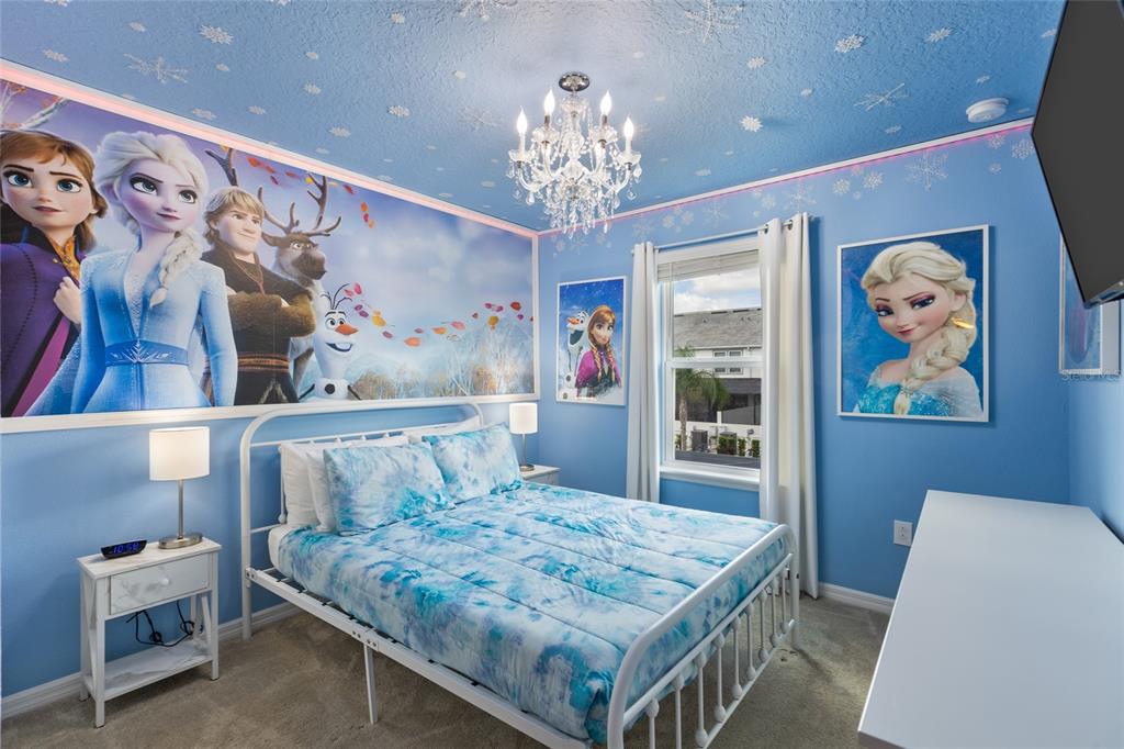 7160 Oakmoss Loop Davenport, FL 33837 - Photo 16 of 45 a bedroom with a bed and a dresser