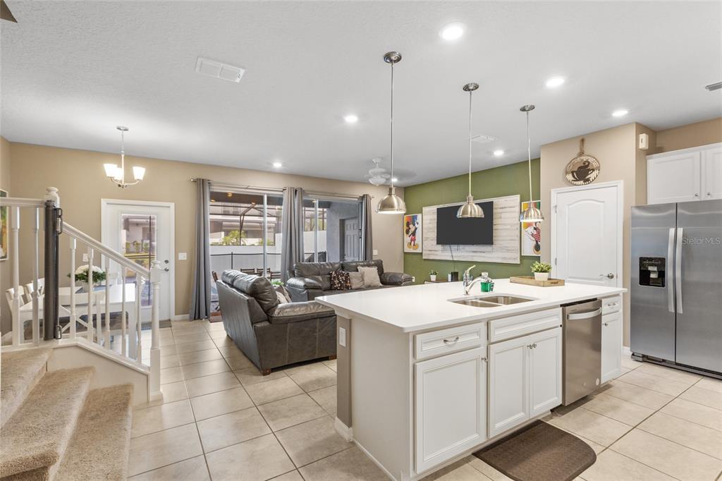 7160 Oakmoss Loop Davenport, FL 33837 - Photo 2 of 45 a large white kitchen with a large window and stainless steel appliances