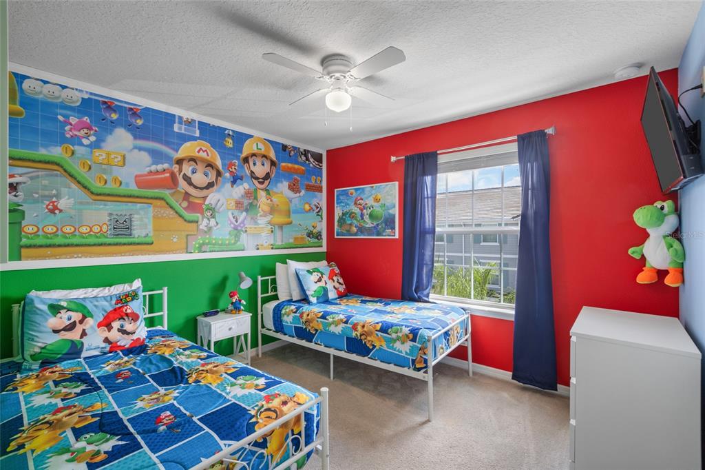 7160 Oakmoss Loop Davenport, FL 33837 - Photo 21 of 45 a bedroom with toys and a wooden floor