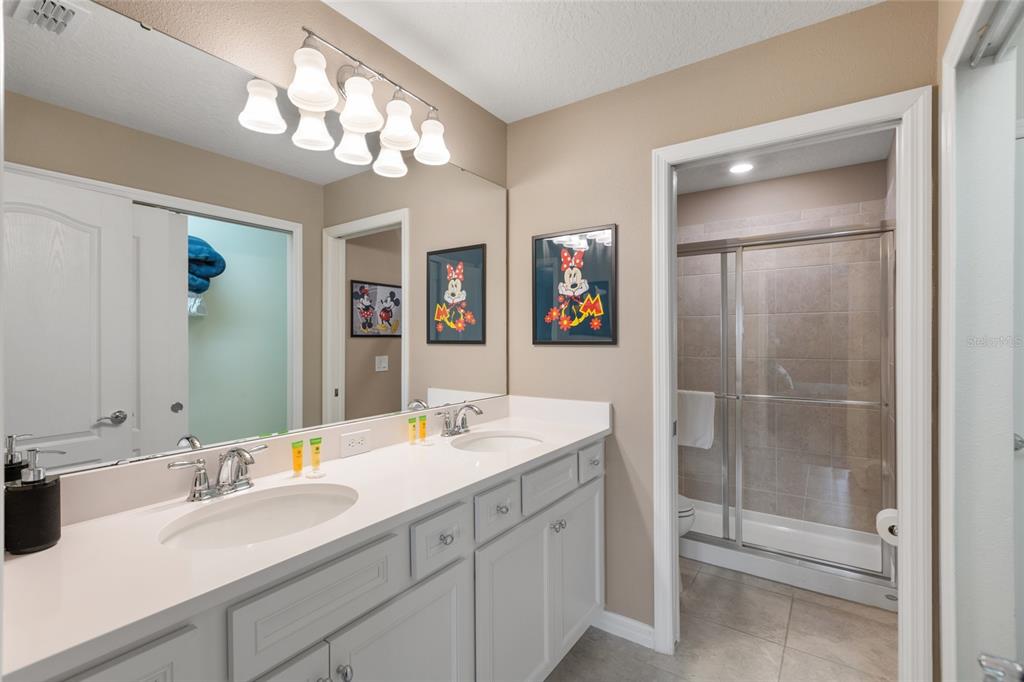 7160 Oakmoss Loop Davenport, FL 33837 - Photo 27 of 45 a bathroom with a sink double vanity and a mirror