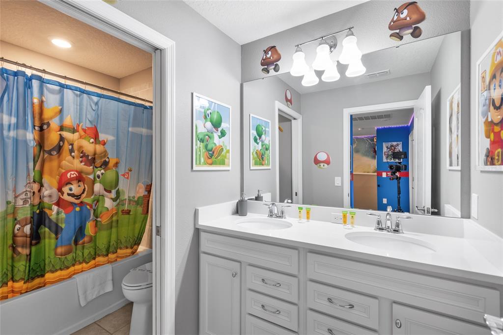 7160 Oakmoss Loop Davenport, FL 33837 - Photo 29 of 45 a bathroom with a sink mirror and a shower