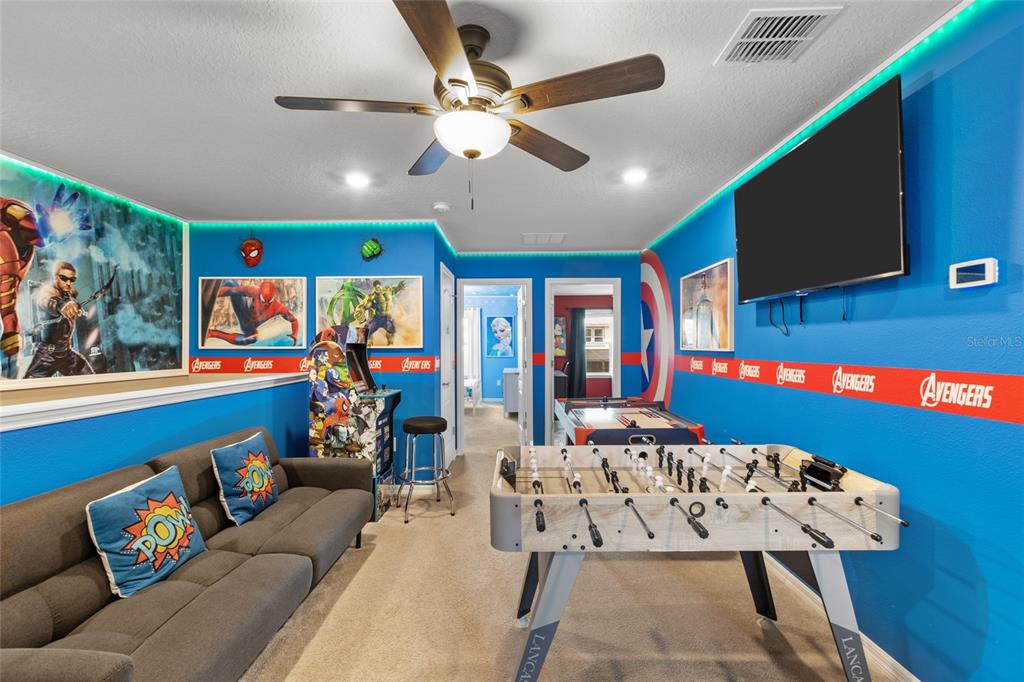 7160 Oakmoss Loop Davenport, FL 33837 - Photo 33 of 45 a living room with furniture and a flat screen tv