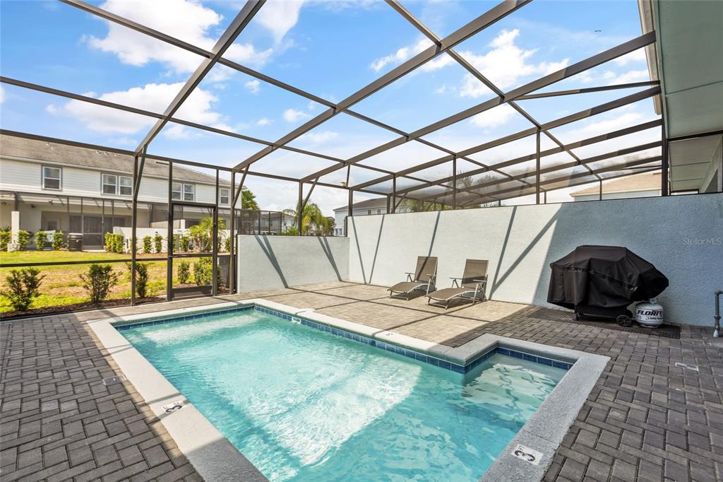 7160 Oakmoss Loop Davenport, FL 33837 - Photo 36 of 45 a view of a swimming pool with a patio