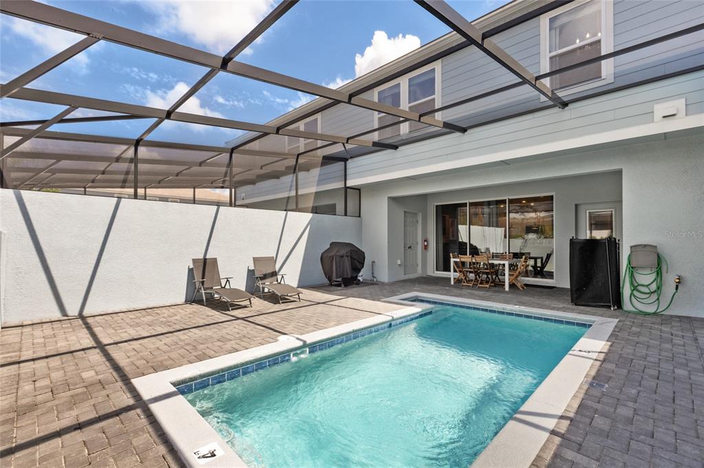 7160 Oakmoss Loop Davenport, FL 33837 - Photo 37 of 45 a view of a backyard with a patio and a garden