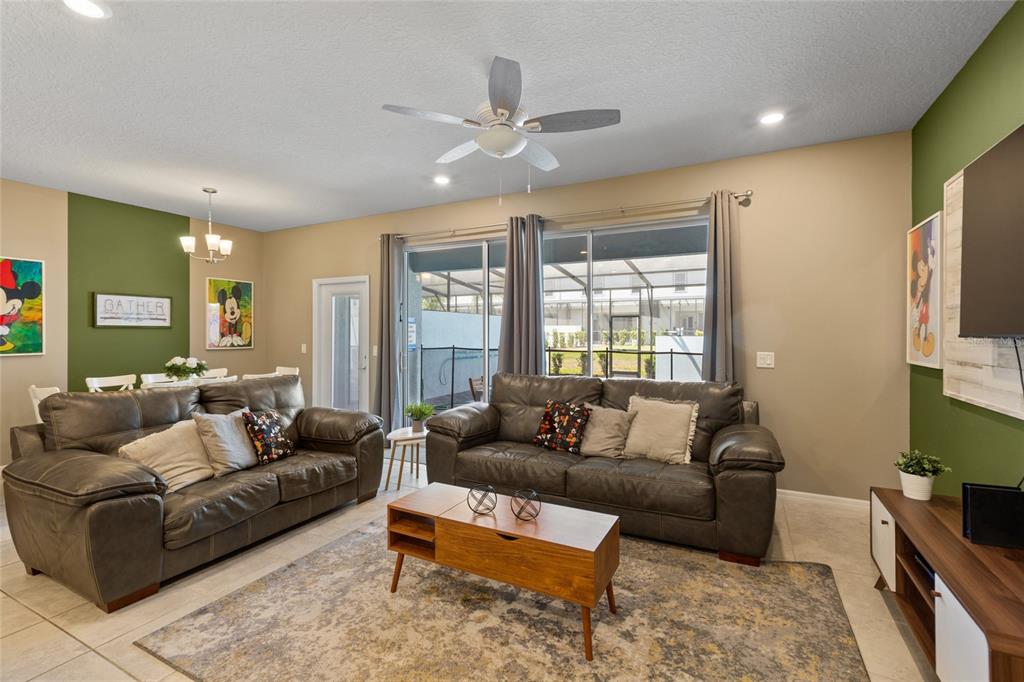 7160 Oakmoss Loop Davenport, FL 33837 - Photo 8 of 45 a living room with furniture and a flat screen tv