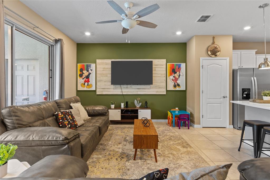 7160 Oakmoss Loop Davenport, FL 33837 - Photo 10 of 45 a living room with furniture and a flat screen tv