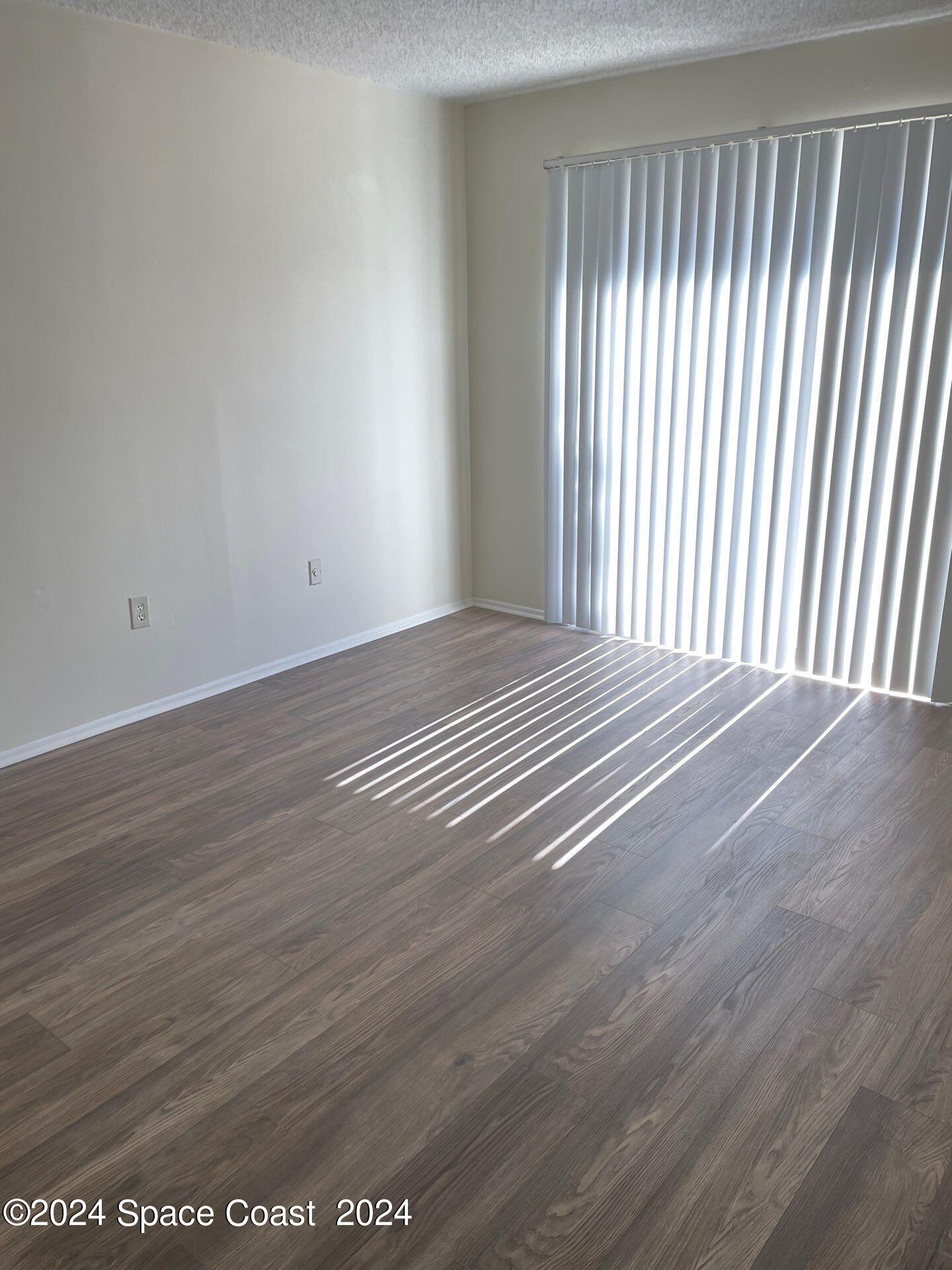 3250 Beach View Way Melbourne Beach, FL 32951 - Photo 6 of 7 a view of a room with wooden floor and a window