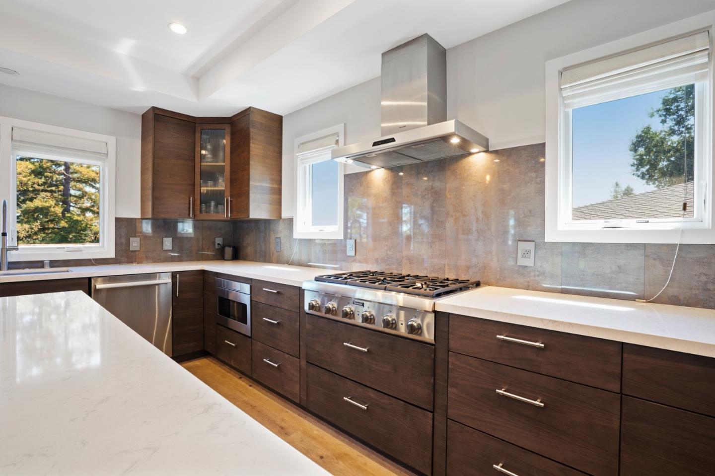 313 Oakview Drive San Carlos, CA 94070 - Photo 14 of 47 a kitchen with granite countertop a stove a sink and a cabinets