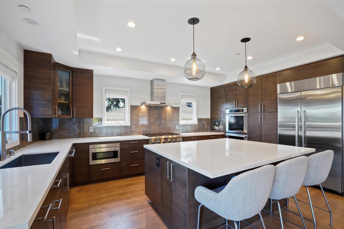 313 Oakview Drive San Carlos, CA 94070 - Photo 15 of 47 a large kitchen with granite countertop a sink counter space stainless steel appliances and cabinets