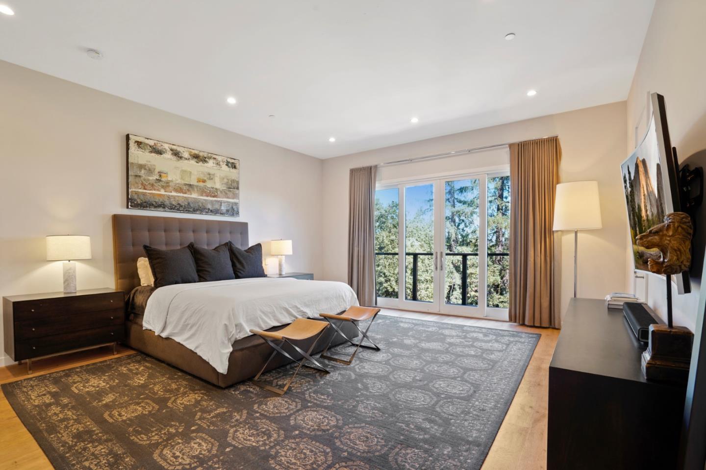 313 Oakview Drive San Carlos, CA 94070 - Photo 35 of 47 a spacious bedroom with a large bed and a flat tv screen