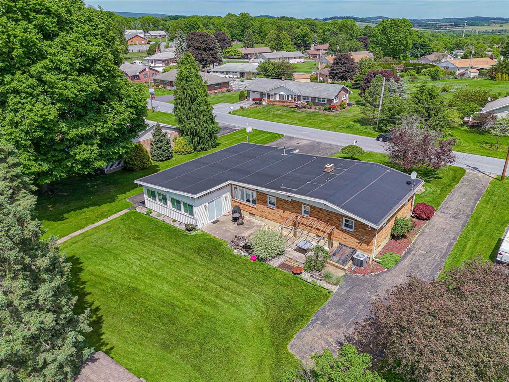 579 Cherry Road Northampton, PA 18067 - Photo 54 of 57 An aerial perspective showcases a charming brick residence amidst a vibrant green yard, complete with an inviting patio space.