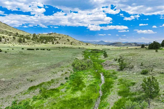 a view of a big yard with lots of green space