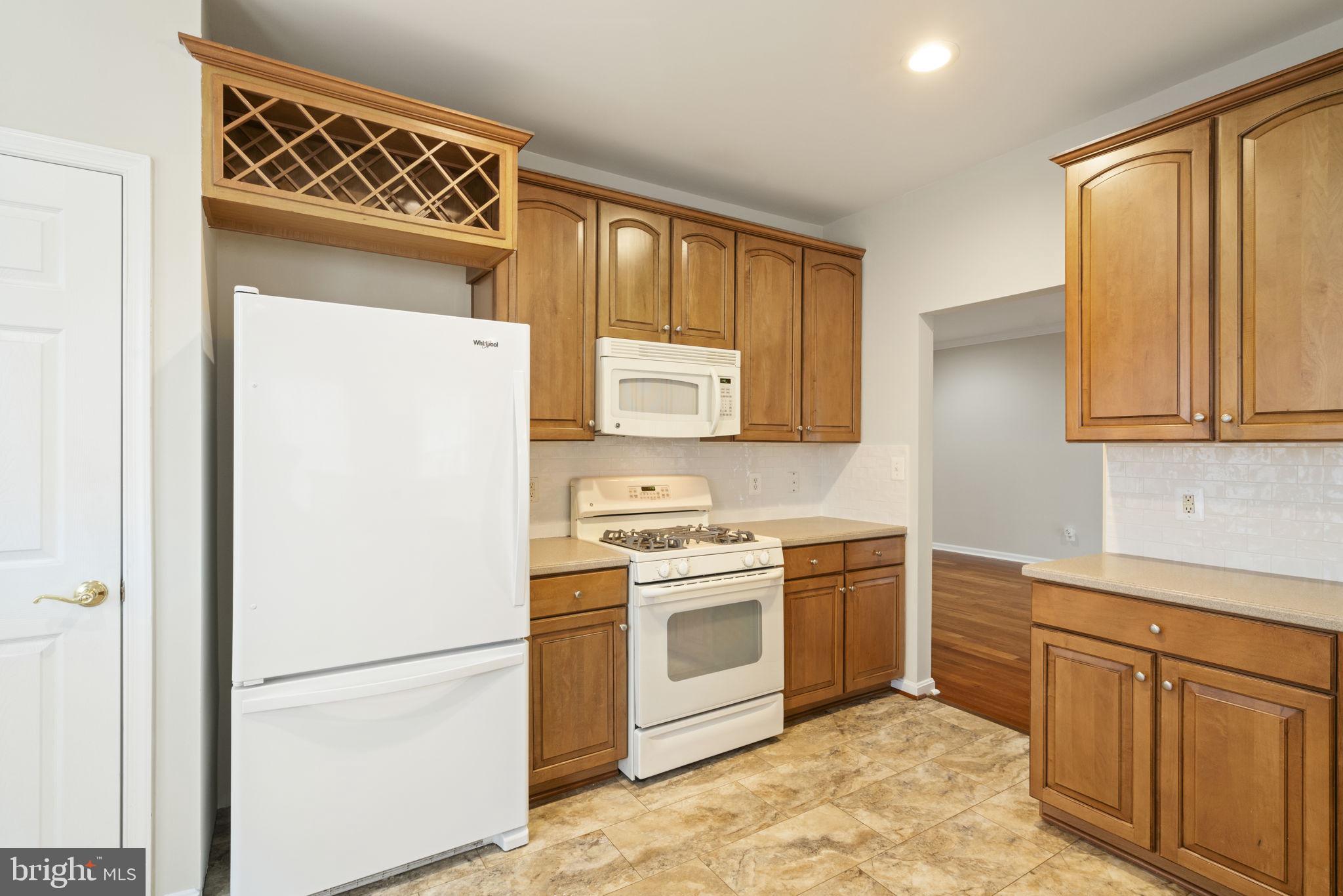 20751 Royal Palace Square, Unit 104 Sterling, VA 20165 - Photo 14 of 44 a kitchen with a refrigerator sink and cabinets