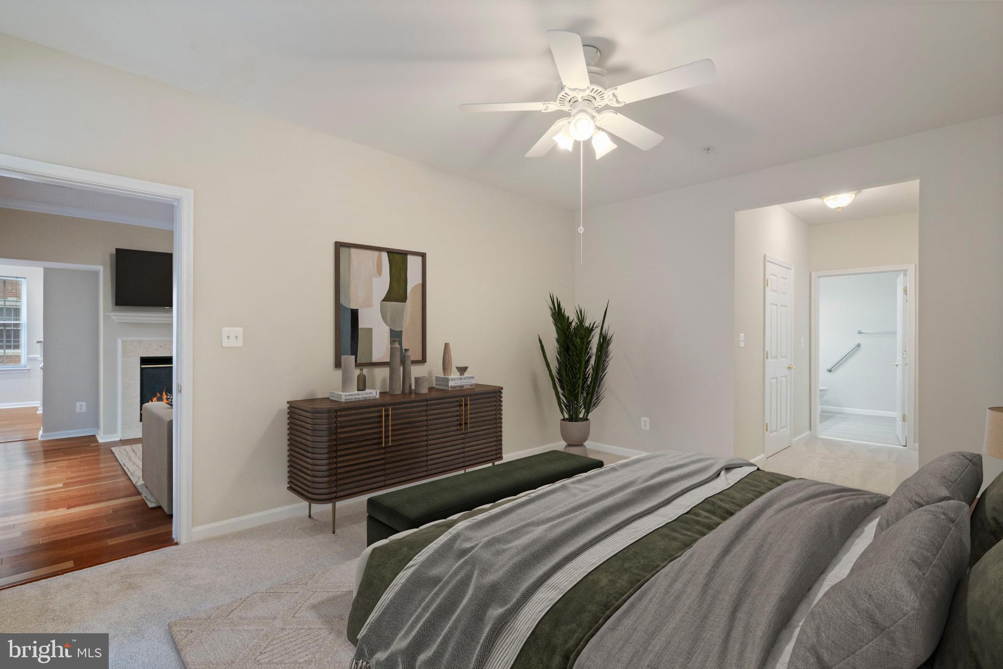 20751 Royal Palace Square, Unit 104 Sterling, VA 20165 - Photo 23 of 44 a bedroom with a bed and a chandelier