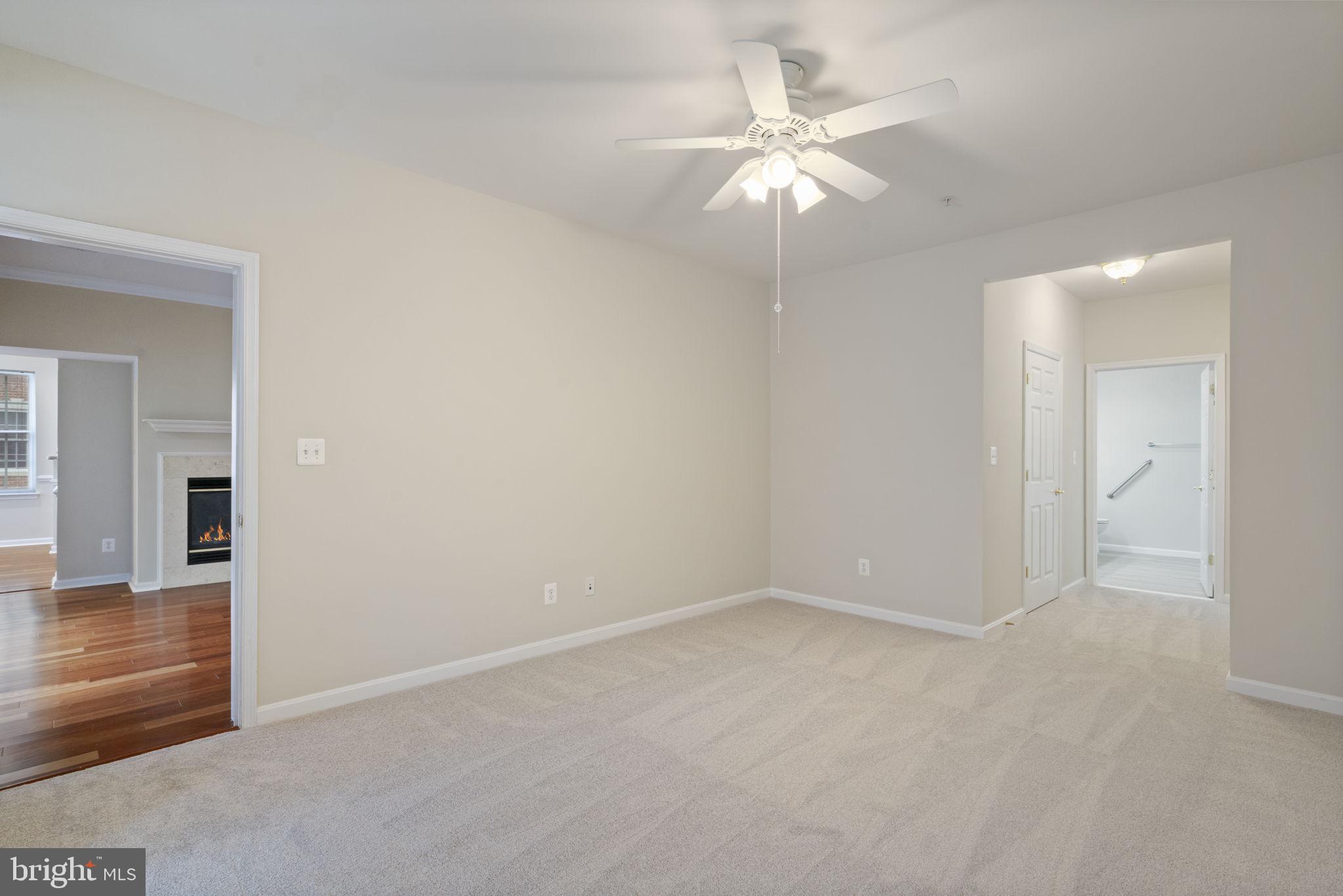 20751 Royal Palace Square, Unit 104 Sterling, VA 20165 - Photo 24 of 44 an empty room with chandelier fan and windows