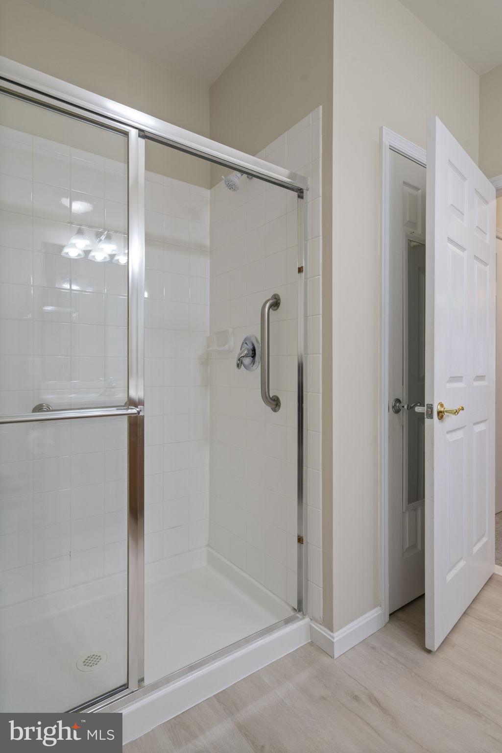 20751 Royal Palace Square, Unit 104 Sterling, VA 20165 - Photo 30 of 44 a bathroom with a glass shower door