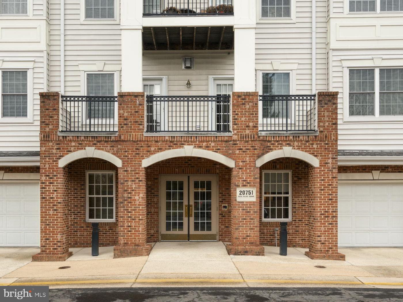 20751 Royal Palace Square, Unit 104 Sterling, VA 20165 - Photo 4 of 44 a front view of a house with a door