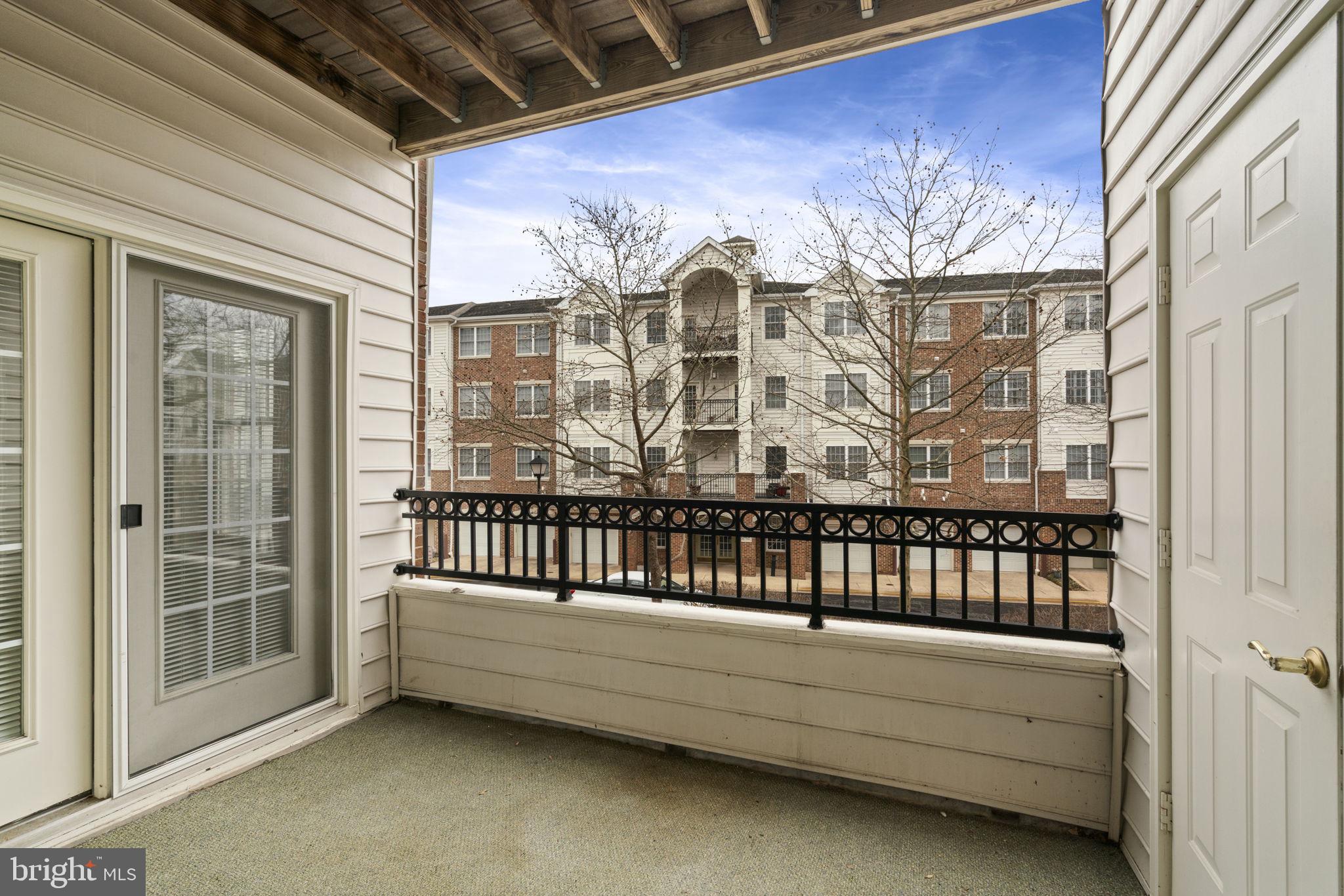 20751 Royal Palace Square, Unit 104 Sterling, VA 20165 - Photo 40 of 44 a view of a porch with a bench