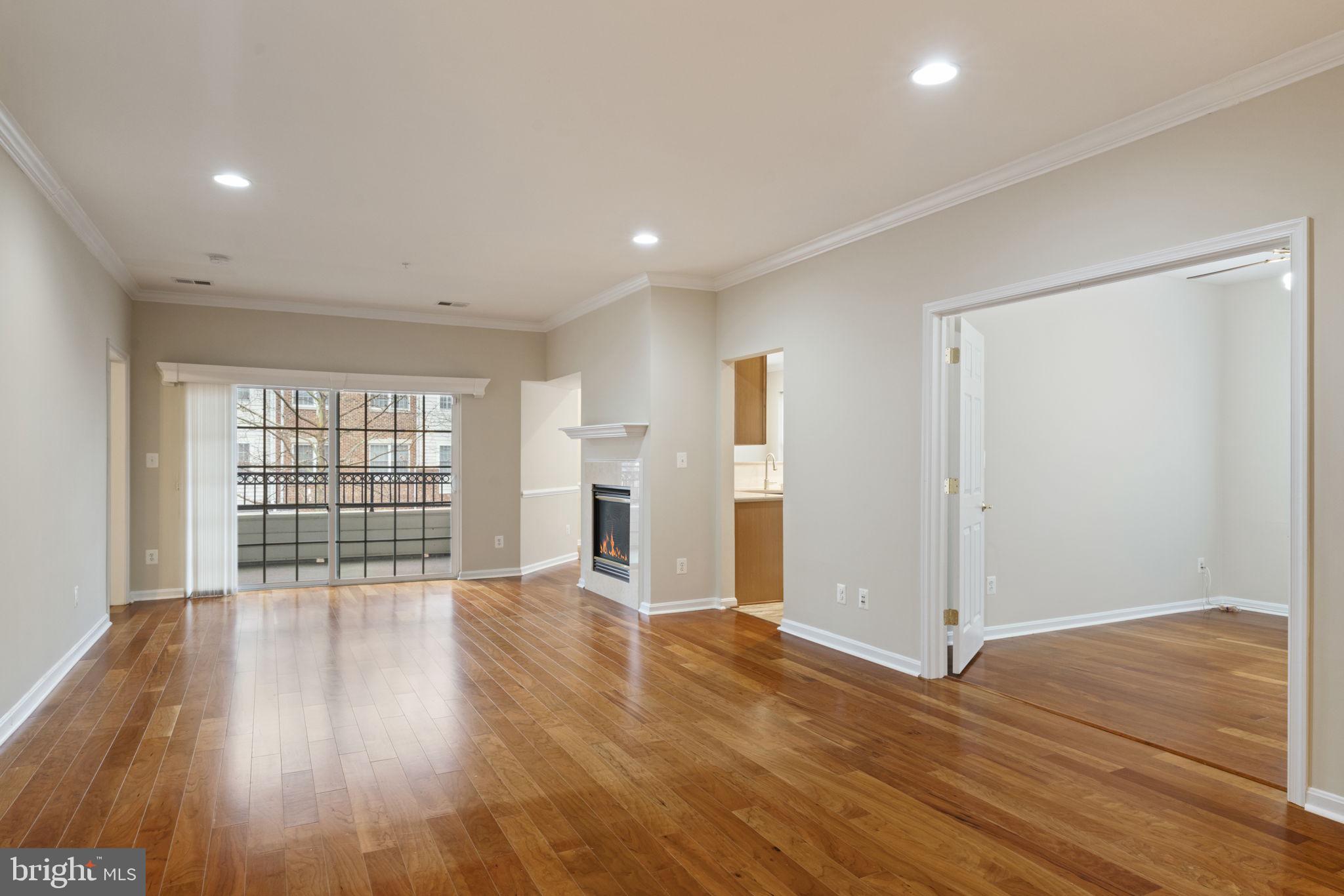 20751 Royal Palace Square, Unit 104 Sterling, VA 20165 - Photo 44 of 44 a view of an empty room with wooden floor and a window